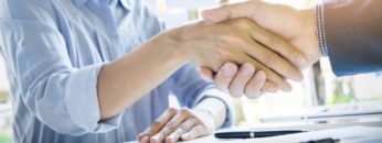Businessmen shaking hands during a meeting.