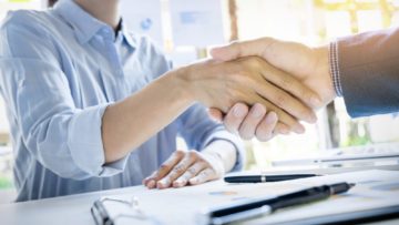 Businessmen shaking hands during a meeting.