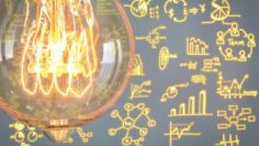 Close up of vintage glowing light bulb with business graph