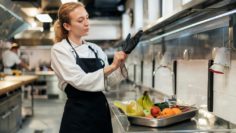 female-chef-putting-glove-kitchen