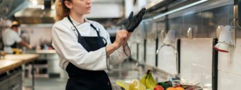 female-chef-putting-glove-kitchen