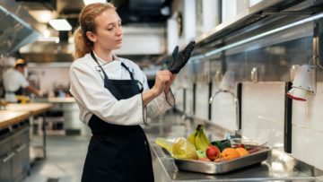 female-chef-putting-glove-kitchen