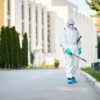 man-protective-suit-disinfecting-city-streets-coronavirus-pandemic