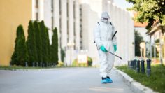 man-protective-suit-disinfecting-city-streets-coronavirus-pandemic