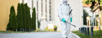 man-protective-suit-disinfecting-city-streets-coronavirus-pandemic