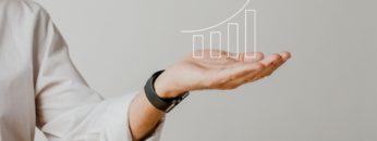 digital-increasing-bar-graph-with-businessman-hand-overlay