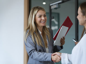 side-view-women-shaking-hands